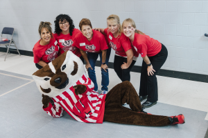 The Office of Child Care and Family Resources team poses for a photo with Bucky Badger.